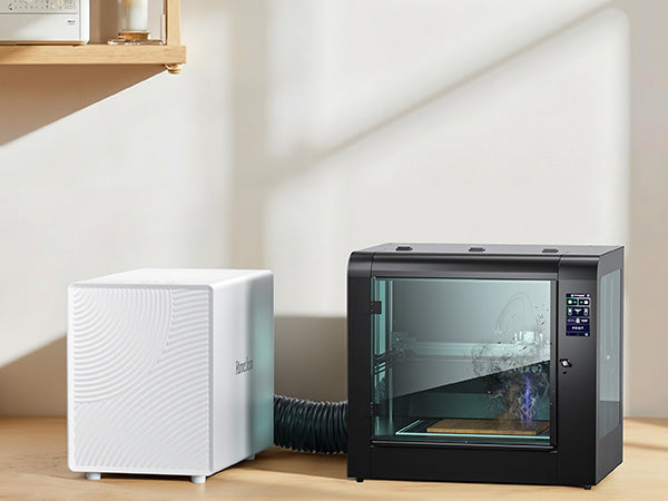 FumeClear FC-2001X compact laser smoke purifier connected to laser engraver via hose, effectively extracting fumes for a clean and healthy workspace